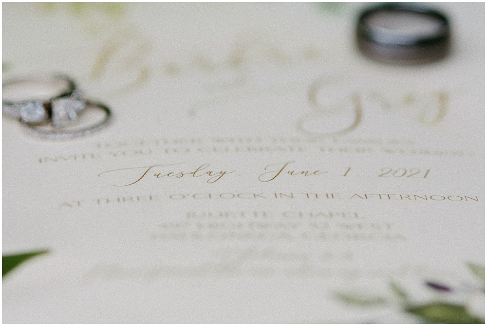 flowery branch wedding photographer takes pictures of the wedding invitations at Juliette Chapel, a wedding venue in Dahlonega, Ga, hidden wooded wedding venue 