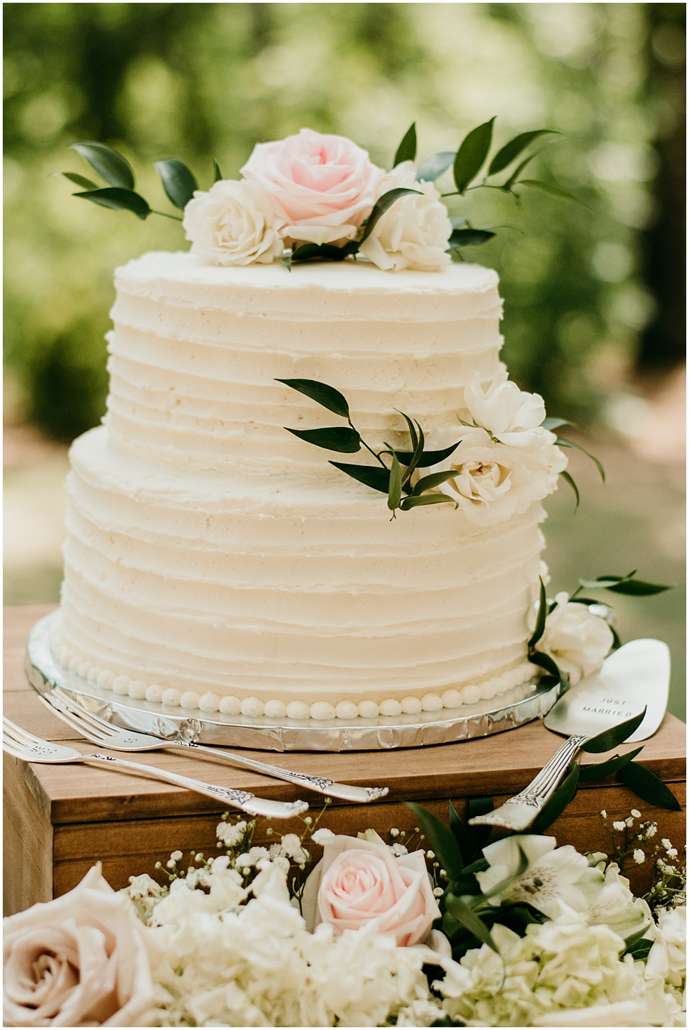 flowery branch wedding photographer takes pictures of the wedding cake at Juliette Chapel, a wedding venue in Dahlonega, Ga, hidden wooded wedding venue 