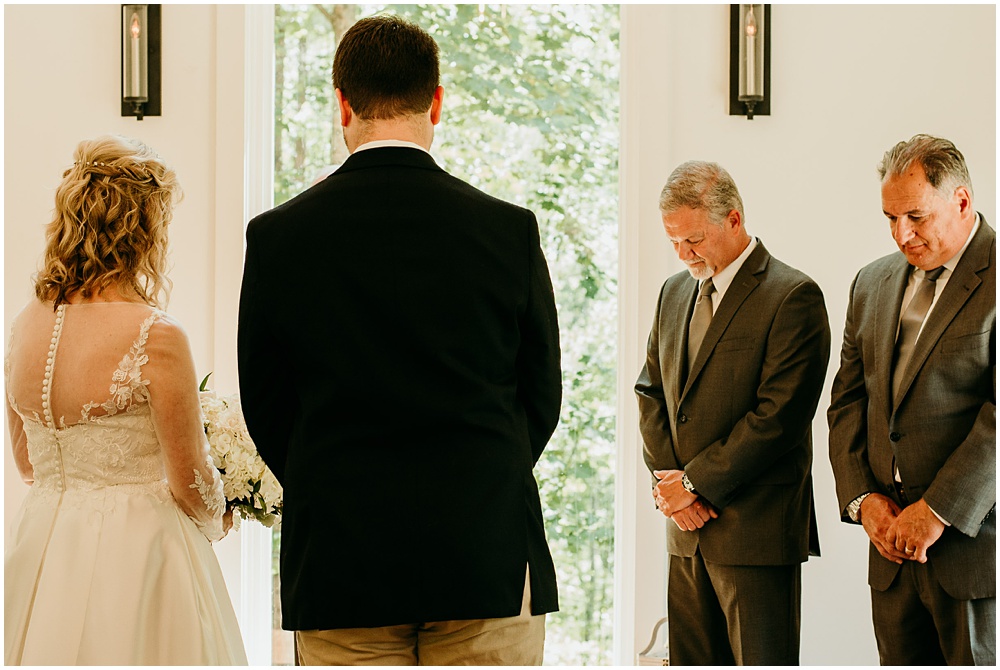 flowery branch wedding photographer takes pictures of the wedding ceremony at Juliette Chapel, a wedding venue in Dahlonega, Ga, hidden wooded wedding venue 