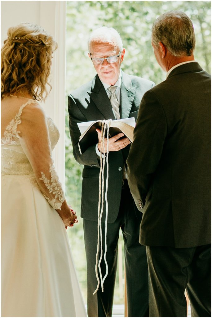 flowery branch wedding photographer takes pictures of the wedding ceremony at Juliette Chapel, a wedding venue in Dahlonega, Ga, hidden wooded wedding venue 