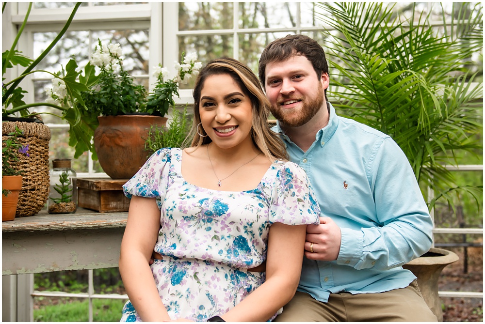 family pose for easter mini session in the greenhouse with Archie the bunny at prospect farms in Lawrenceville, Ga