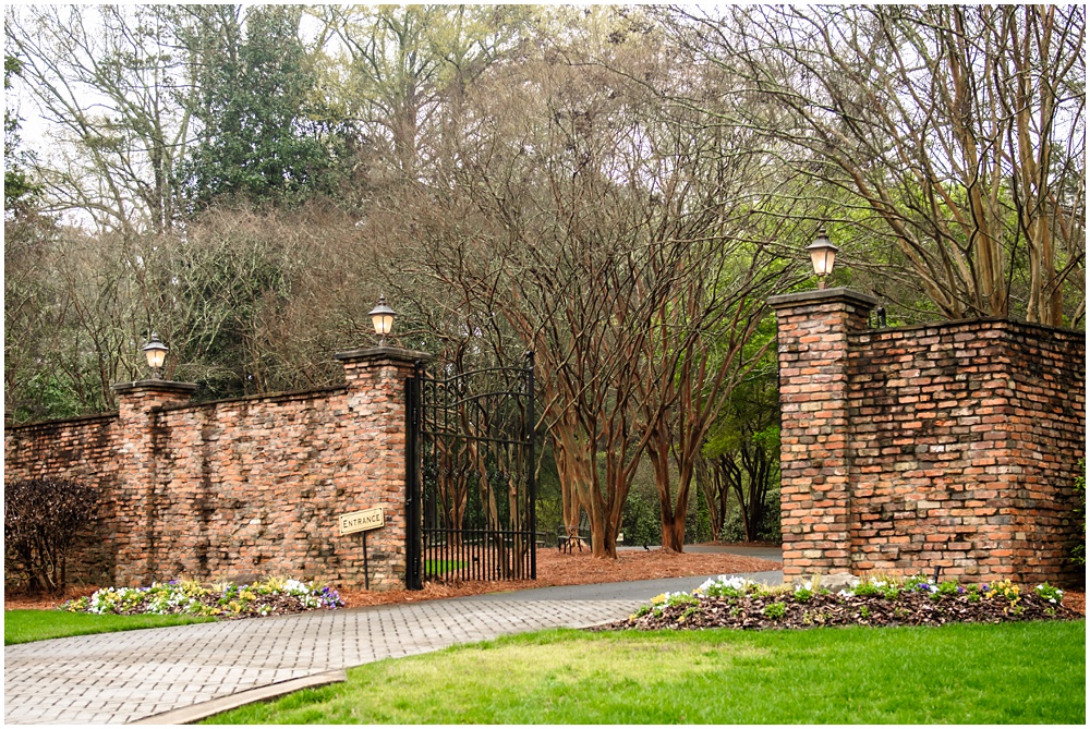 the carl house wedding venue in auburn georgia has a brick gate with an iron gate for privacy. 