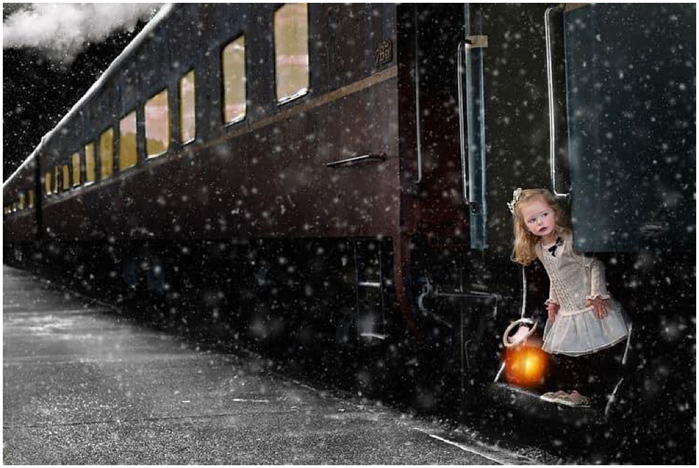 little girl standing outside of a train holding a lantern. polar express photo