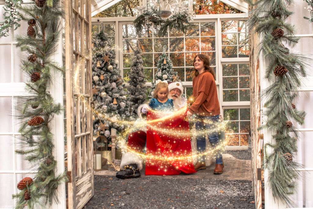 sisters looking into santa's toy bag during their Santa mini session at prospect farms, in lawrenceville ga 