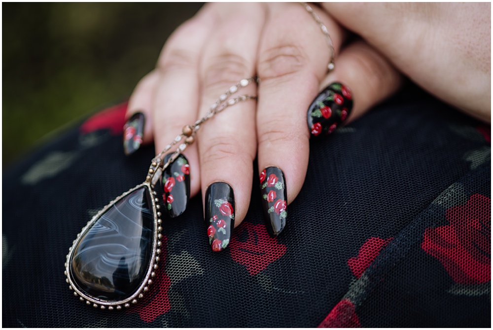 Bride posing with jewelry during an engagement session at Oakland Cemetery in Atlanta georgia. Goth bride 2025