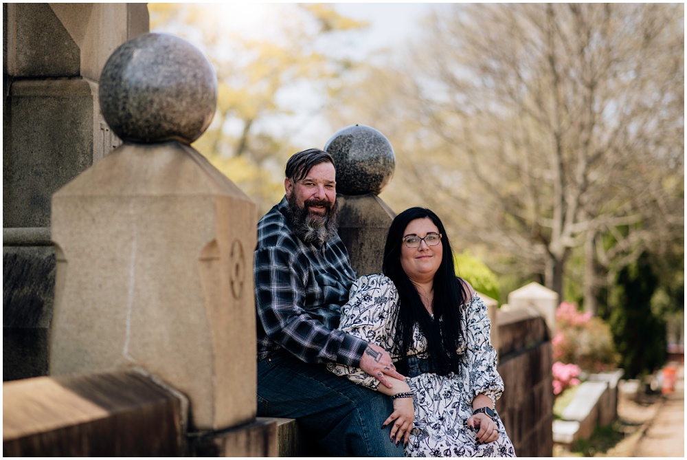 Bride & Groom posing on steps during an engagement session at Oakland Cemetery in Atlanta georgia. Goth bride 2025