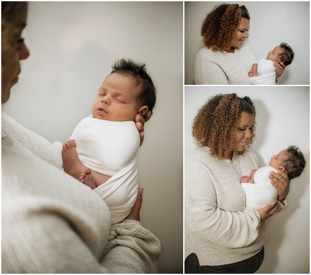 Flowery Branch photographer takes photo of the baby and his mom during the newborn session in the studio. Everyone is all smiles.