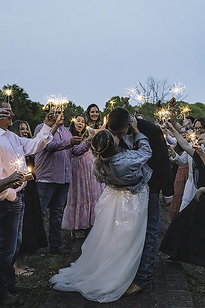 North Georgia photographer photographs a wedding in the country for a young couple in the north Georgia mountains. Photographed here is the Bride and Groom leaving, walking through sparklers. 