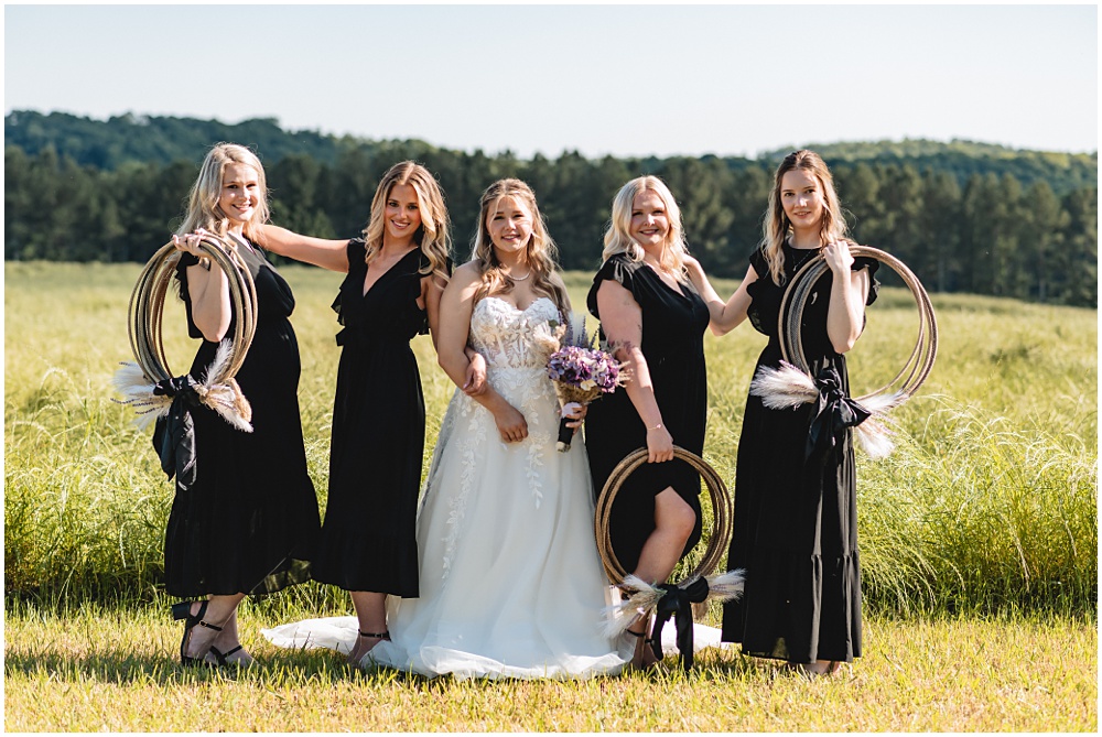 North Georgia photographer photographs a wedding in the country for a young couple in the north Georgia mountains. Photographed here is the Bride and Bridesmaids out in the field 